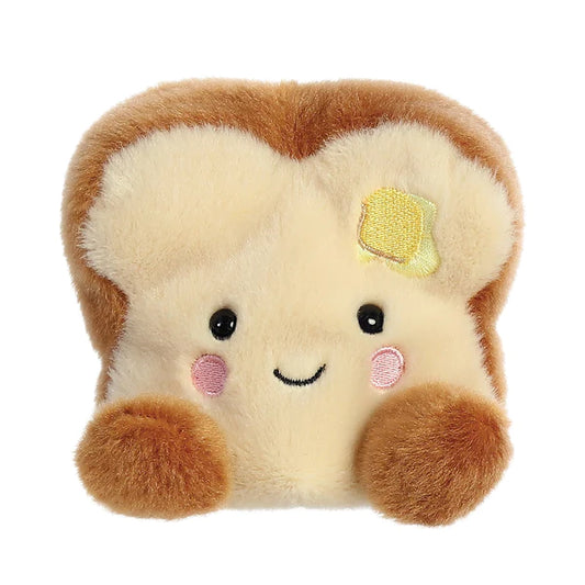 A small, brown plush toast soft toy with a smiling face, designed to fit in the palm of your hand. Full of beans for extra softness and cuddliness. Made from eco-friendly materials, including recycled plastic beans and fiber fill. Measures 13cm. 