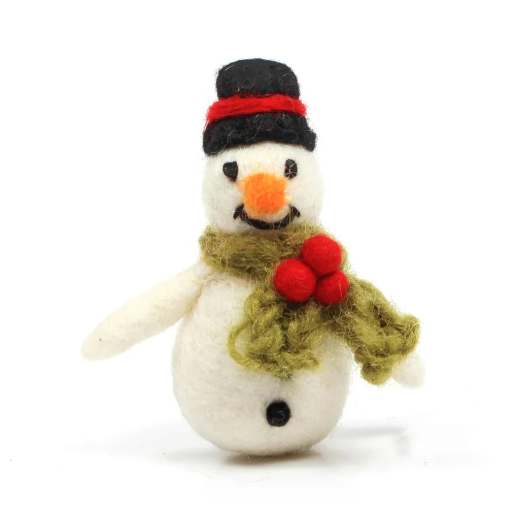 A small handmade wool snowman with a red and black striped hat, green scarf with red holly, and a smiling face.