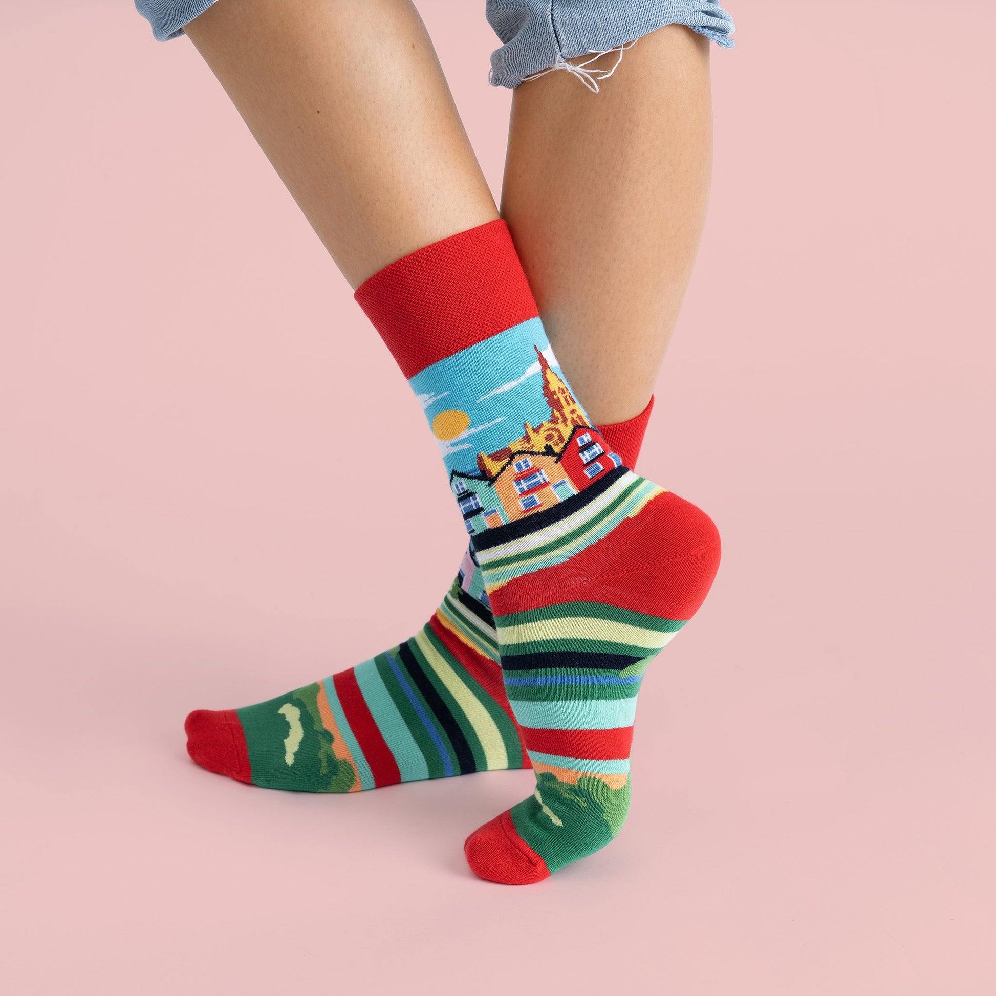 The previous socks on a models feet showing the design wrapping around the sock.