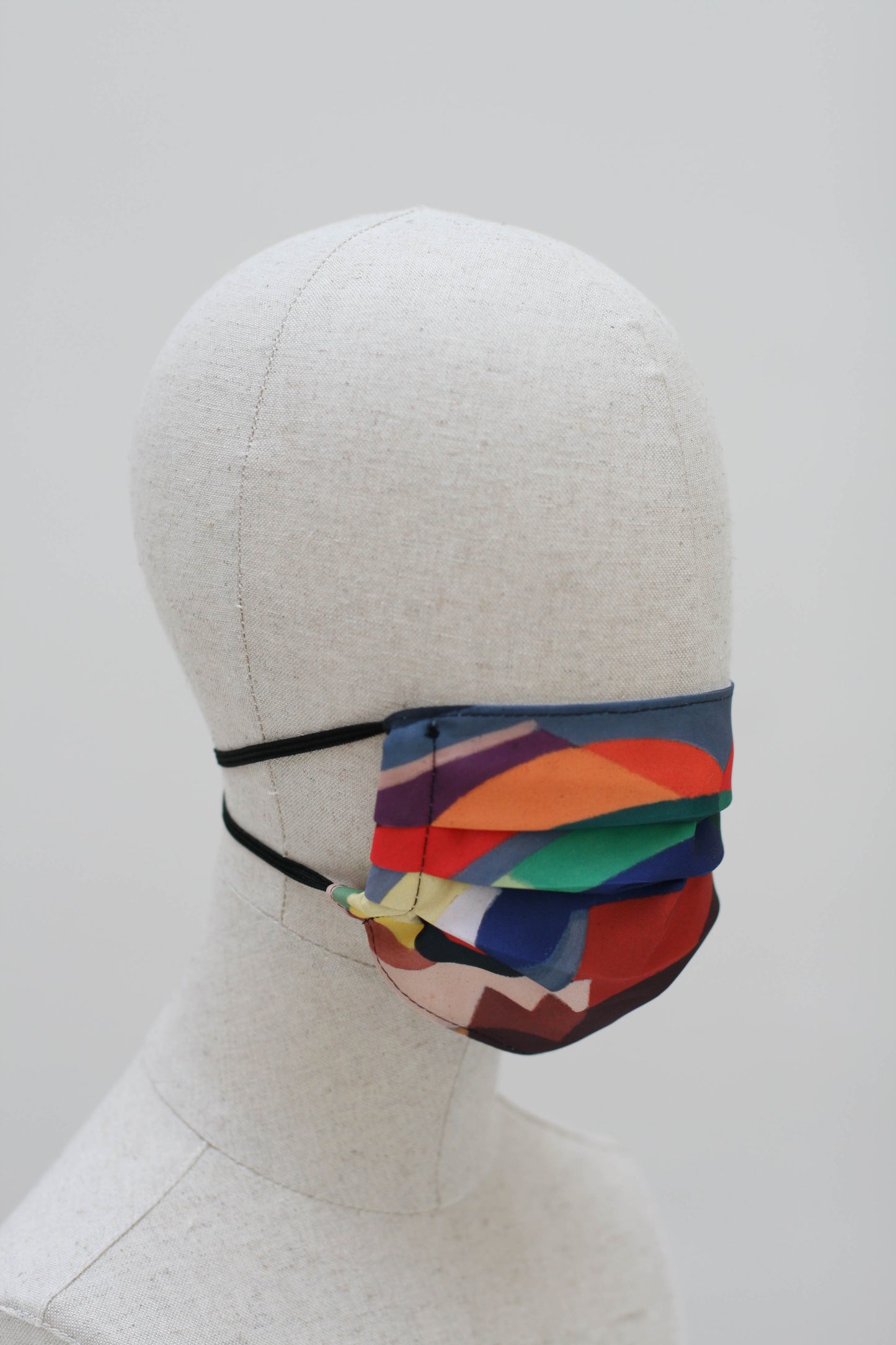 The mask on a mannequin head from the other side.