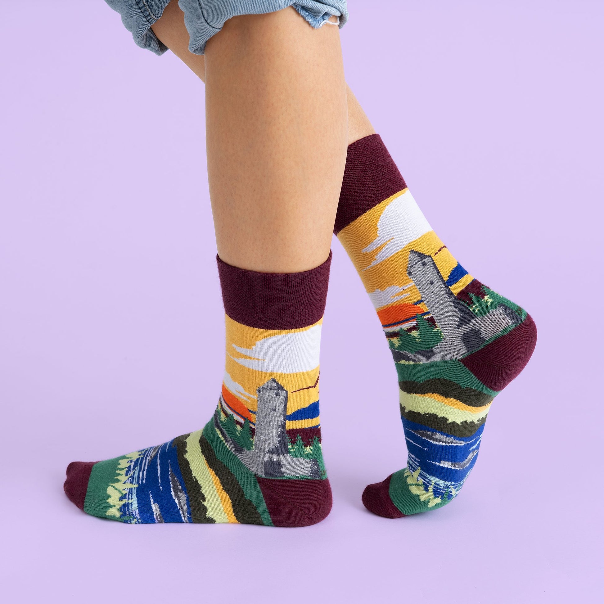 The previous socks on a models feet showing the design wrapping around the sock.