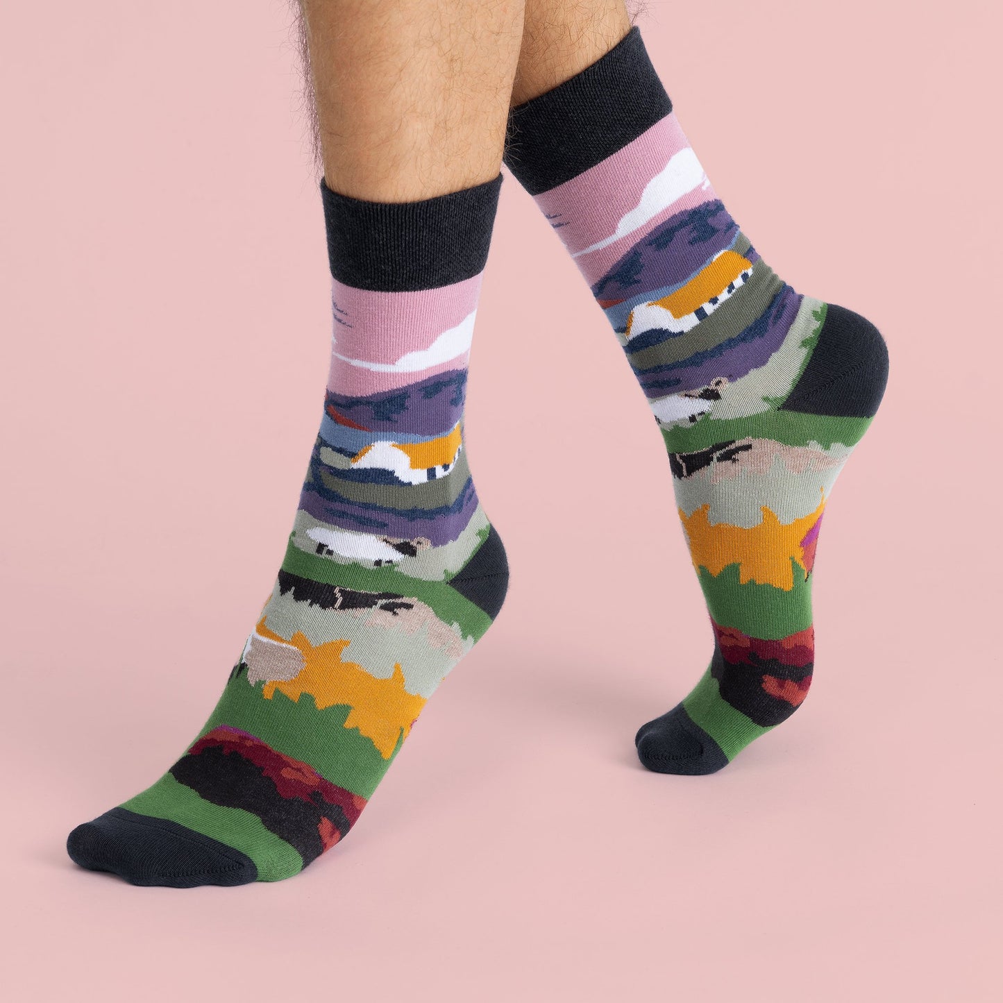 The previous socks on a models feet showing the design wrapping around the sock.