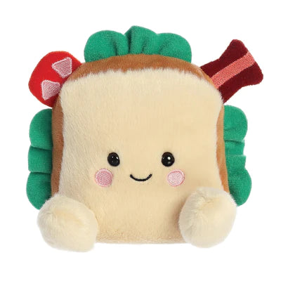 "Alt text: A small, brown plush BLT sandwich soft toy with a smiling face, designed to fit in the palm of your hand. Full of beans for extra softness and cuddliness. Measures 13cm. 