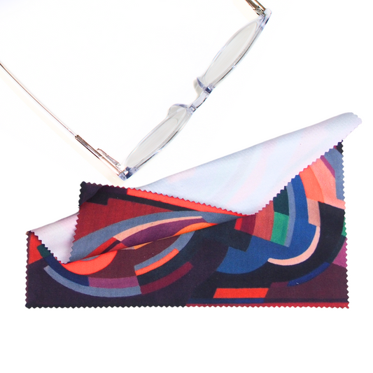 Colorful lens cleaning cloth featuring A Composition by Mainie Jellett on a white background next to a pair of glasses (not included).