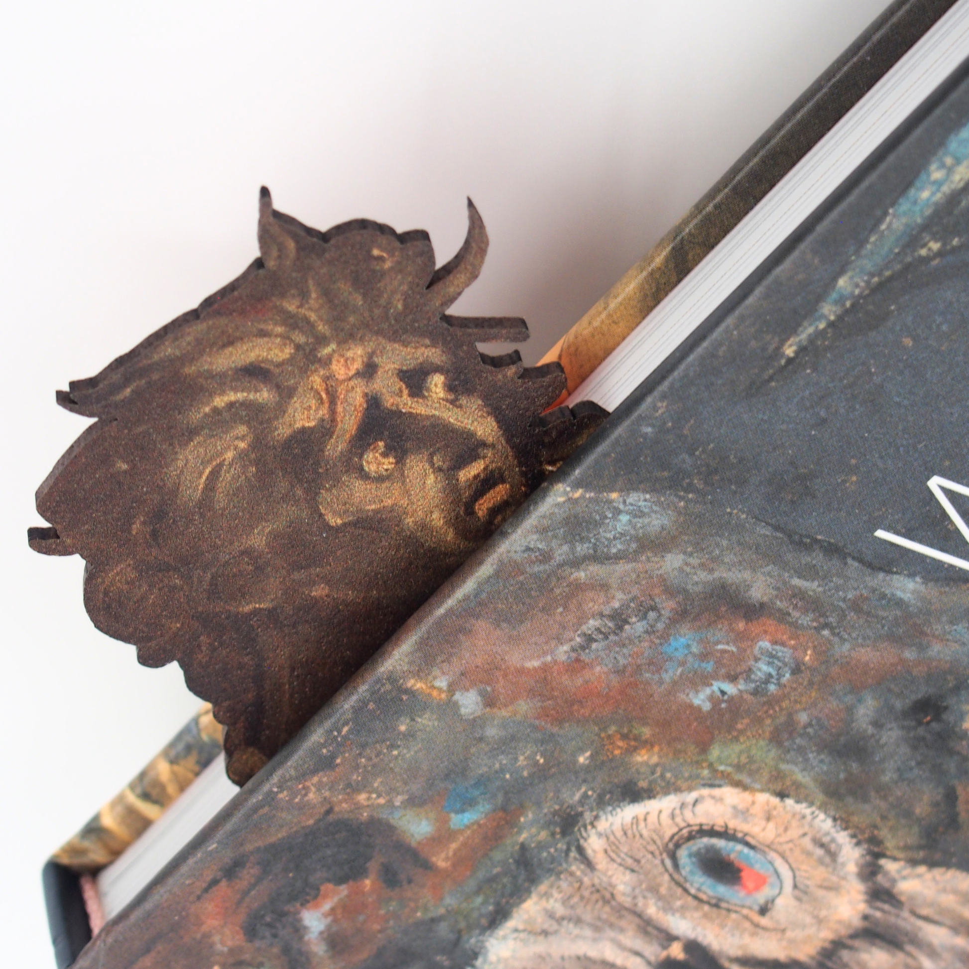 Close up of bookmark featuring figure from 'Lady Macbeth Seizing the Daggers' by Fuseli. Shown being used in the exhibition catalogue, 'William Blake: The Age of Romantic Fantasy'