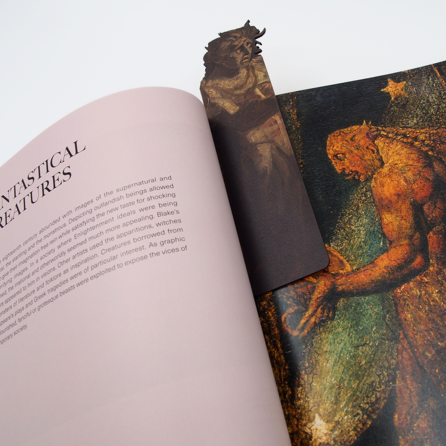 A wooden bookmark of a figure from 'Lady Macbeth Seizing the Daggers' by Fuseli. Shown in use in the exhibition catalogue, 'William Blake: The Age of Romantic Fantasy'