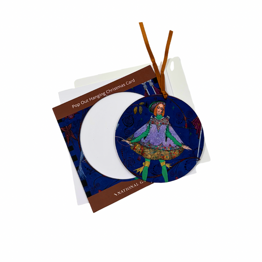 A circular pop-out hanging Christmas card featuring an illustrated figure in a purple and green outfit on a dark blue background, shown with its brown backing card and white insert on a white studio background.