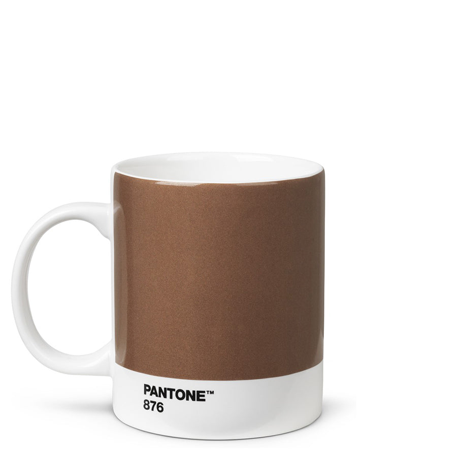 A cup that is mainly shiny brown with a white stripe around the bottom with ‘Pantone 876’ in small black capitals. It has a white handle and white inside.