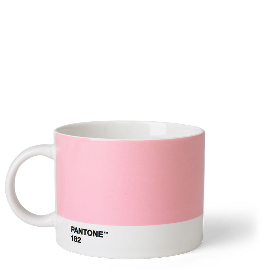 A wide round cup that is mainly a light pink with a white stripe around the bottom with ‘Pantone 182’ in small black capitals. It has a big white handle and white inside.