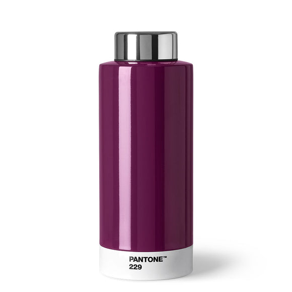 A shiny cylindrical bottle that is mainly dark purple with a white stripe around the bottom with ‘Pantone 229’ in small black capitals, and a silver lid.