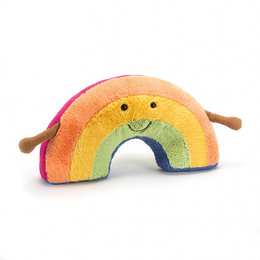 A soft toy rainbow with small arms and a simple smiling face.