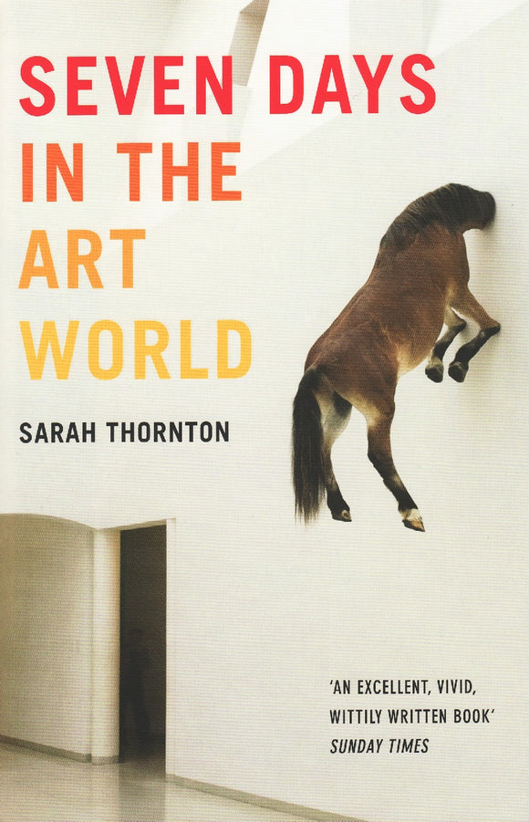 A photo of a brown horse, in the air, with its head through a white wall. The title is on the top left in a gradient from red to orange to yellow capital letters.