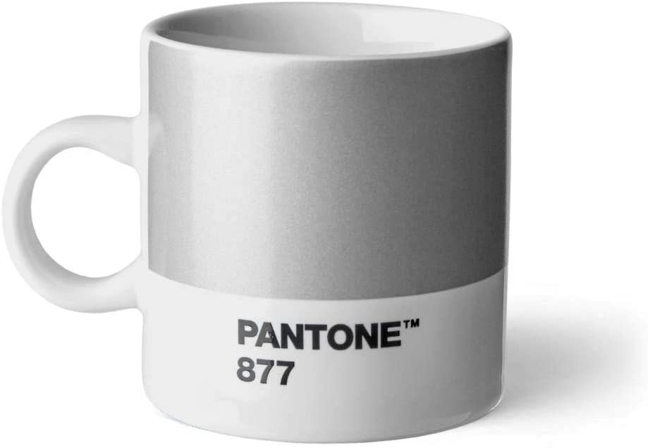 A short cup with a wide panel of silver around the top two thirds. Underneath is a white stripe with ‘Pantone 877’ in small black capitals. It has a small white handle and white inside.