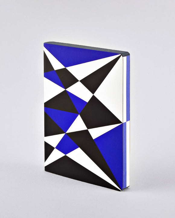 A notebook covered in an angled geometric pattern in white, black, and blue, that continues onto the paper edges.