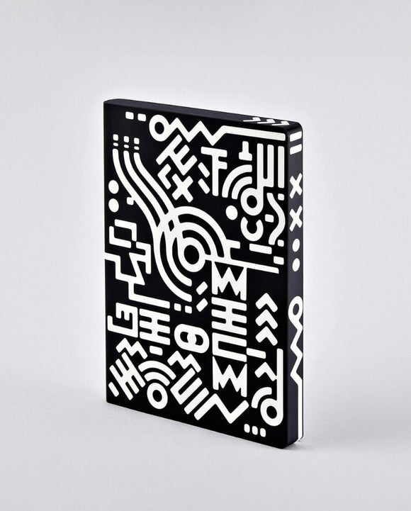 A notebook covered in a white pattern of lines and shapes against black that continues onto the paper edges.
