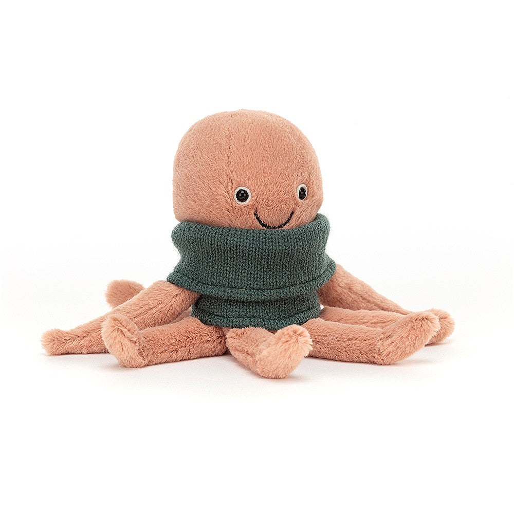 A light pink, soft octopus toy with a smiling face wearing a green knit polar neck top.