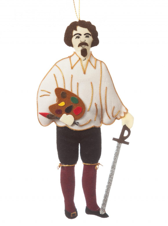 A felt man with a goatee, loose white shirt and wine knee high socks, detailed in gold thread, holding a silver sword and mini paint palette and brush, hanging from a golden thread.
