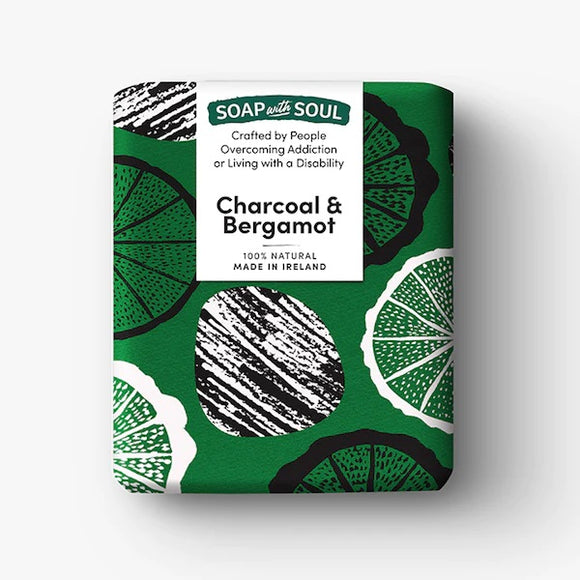 A dark green box with a simple pattern of circles in black and white. A white square has the product brand and details.