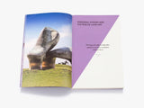 A photo of a large grey abstract sculpture on the left page. The right is the chapter heading, cut diagonally in purple.