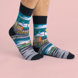 The previous socks on a models feet showing the design wrapping around the sock.