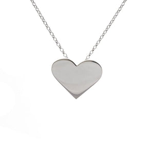 A flat silver pendant of a heart hanging from a silver chain.