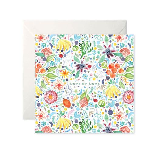 A white card with a colourful painted pattern of fruits and flowers. ‘Lots of Love’ is in the centre in mint capital letters.