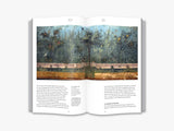 A two page spread of a forest scene painted on an aged wall. There is text underneath.