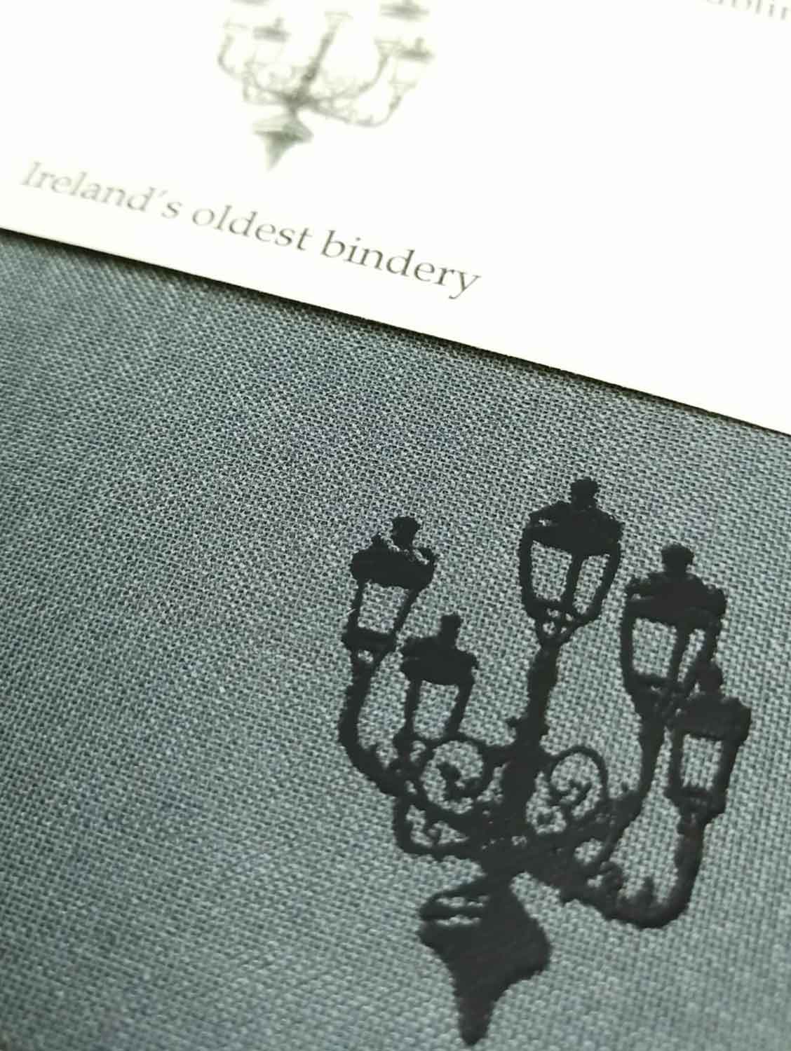 A close up of the lamp illustration also showing the texture of the grey cloth cover.