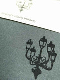A close up of the lamp illustration also showing the texture of the grey cloth cover.