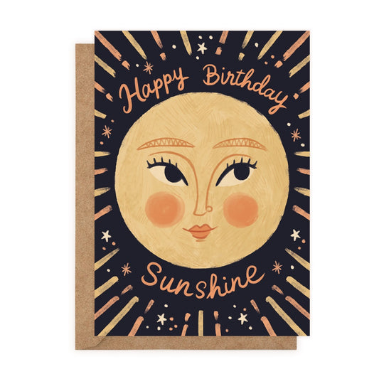 A drawing of sun with a smiling expression on a navy card. Happy Birthday Sunshine is in orange cursive above and below.