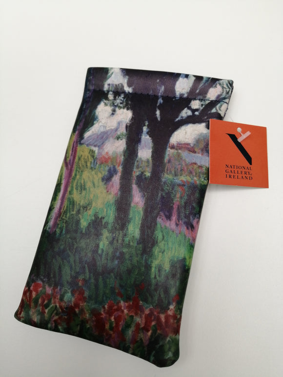 A rectangular pouch with an orange label. An expressionist landscape of prominent trees with a house and wall visible in the background. The trees are in shade, with green and red plants on the forest floor.