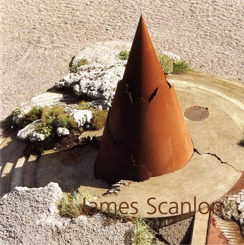 A photo of a large terracotta coloured cone with jagged edges, at the top of a circle of steps on the sand. The title is in the bottom right in thin, brown letters.