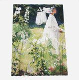 A woman in white walks towards the right of the image. White, long stemmed lilies dominate the foreground and up the left side of the image, effectively framing the woman. The cloth has zig zag edges.