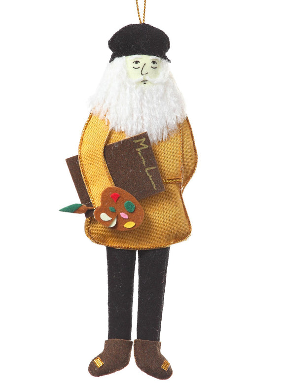 A felt man with a white beard, wearing a black hat and gold tunic, and holding a paint palette, brush and notebook, hanging from a golden thread.