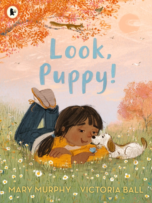 An illustration of a little girl lying on the grasstalking to a puppy in the park. The title is above in light blue.
