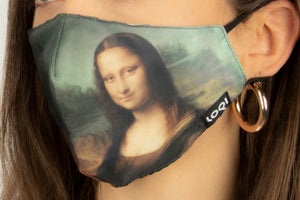 A face mask on a person, shown from a side angle. The mask is of a classical painted landscape, with the Mona Lisa just off side of centre. It has the loqi logo on the edge and the ear straps are black. 