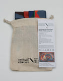 The mask is peaking out of the top of a basic cotton pouch with a draw string top. The Gallery logo is printed in black on the bottom of the pouch.