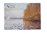 A box with an impressionist painting of a light blue sky and matching coloured lake. The right of the image is dominated by a large tree in autumn oranges which reflects into the water. On the left is a small boat with its white sail open.