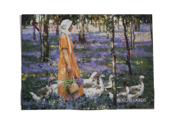 The box is a woman in an orange dress and white bonnet walks through a woods where the forest floor is covered in purple flowers. She has a group of geese around her and carries a basket of the purple flowers.