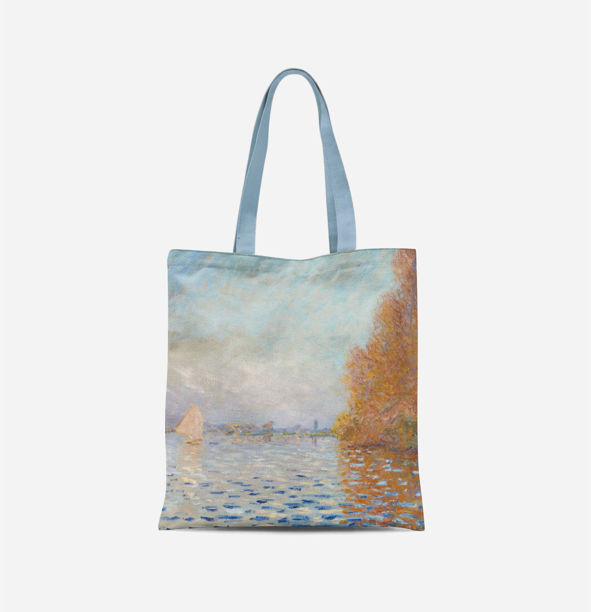 A bag with long light blue handles covered in an impressionist painting of a light blue sky reflecting in a lake, with a large autumnal tree to the right and a small white sail boat to the left.