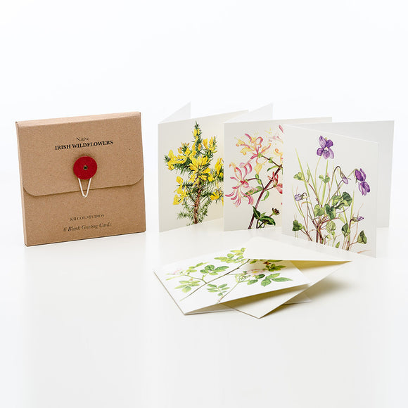 A brown card box. Beside it stand three white cards with illustrations of flowers. The first card has yellow flowers, the second pink flowers, and the last purple flowers.