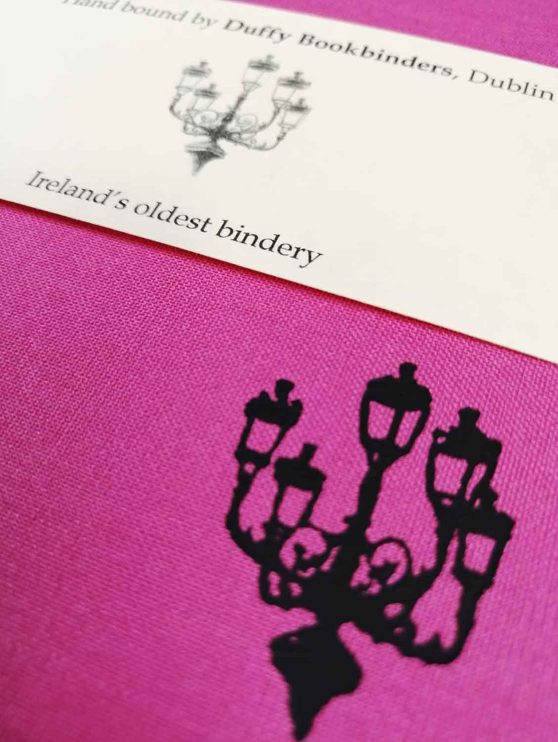 A close up of the lamp illustration also showing the texture of the pink cloth cover.