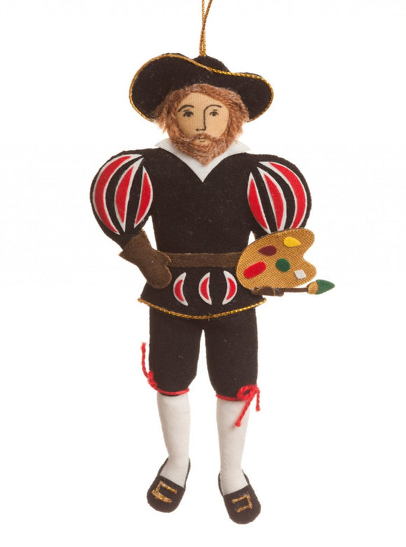 A felt man wearing with a brown beard wearing a black hat and outfit with red striped puff sleeves, holding a paint brush and palette, hanging from a gold thread.
