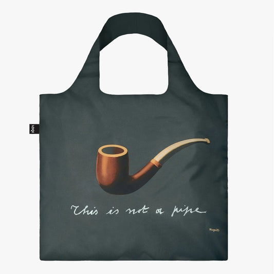 A square, dark grey bag with a large painting of a brown pipe in the centre. ‘This is not a pipe’ is underneath in white cursive.