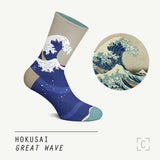 A sock of crashing wave against a grey sky on a mannequin, beside a detail of the painting it is based on.