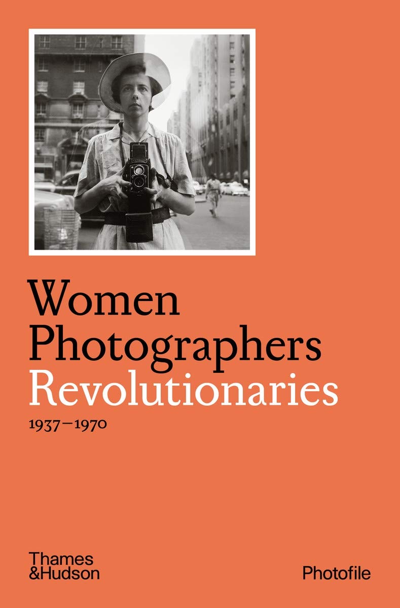 A dark orange cover with a black and white photo in the top left of a woman holding a camera, taking a photo of herself in a window. The title is underneath in black and white letters.
